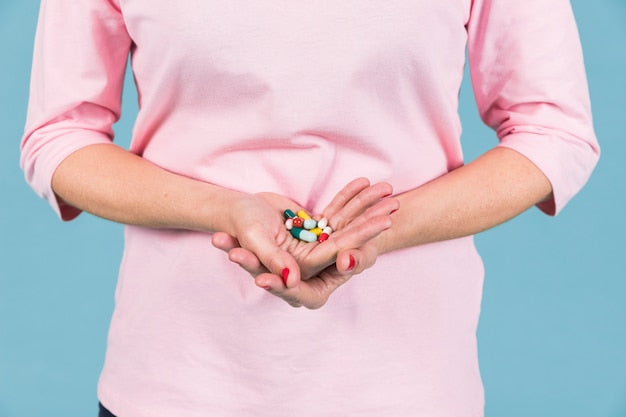 lady holding capsules